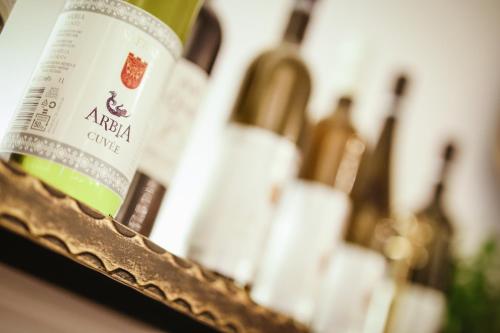 a close up of a bottle of wine in a mirror at Arbia Dorka Heritage Palace in Varaždin