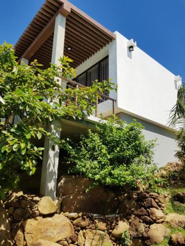 a house on top of a rocky hill at Rumassala Villas in Unawatuna