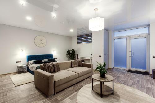 a living room with a couch and a bed at Old Town Trio Apartments in Vilnius