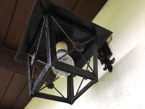a black lantern hanging from the ceiling of a room at Bellamonte Mar in Bellamonte
