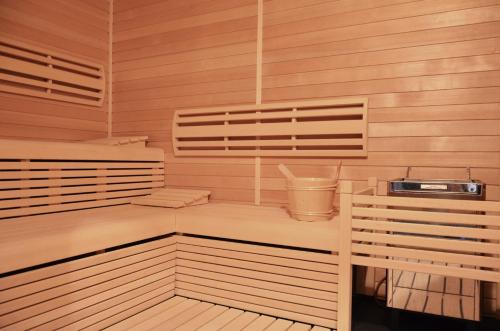 a sauna with wooden walls and wooden floors and a tub at Hotel Panství Dlouhá Lhota in Dlouhá Lhota