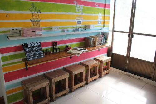 a room with a colorful wall with a shelf and benches at Corner Inn九份住宿I 小角落民宿I 機車租借I日夜間導覽 in Jiufen