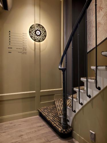 a room with a staircase with a pendant light at Doisy Etoile - Orso Hotels in Paris
