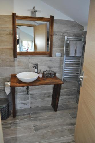 a bathroom with a sink and a mirror at Guesthouse ANKL in Lesce