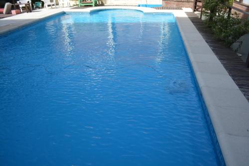 una piscina de agua azul en un edificio de Alamos en Villa Gesell