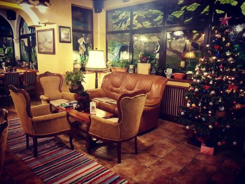a living room with a couch and a christmas tree at Crama Haiducilor in Cluj-Napoca