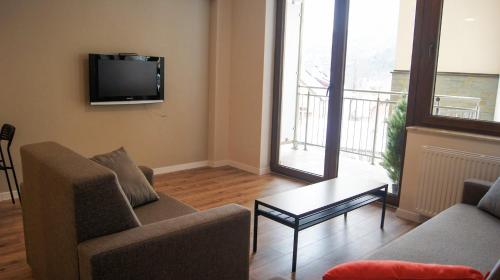 Μια τηλεόραση ή/και κέντρο ψυχαγωγίας στο Apartamenty Opal