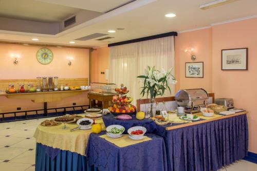 a room with two tables with food on them at Best Western Blu Hotel Roma in Rome