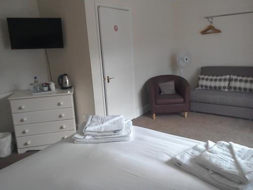 a bedroom with a bed with towels on it at The Queens Head in Stratford-upon-Avon