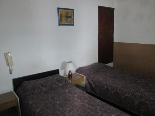 Ένα ή περισσότερα κρεβάτια σε δωμάτιο στο Hotel Perla Central