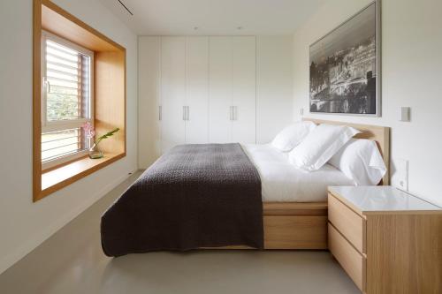 a bedroom with a large bed and a window at Villa Enea by FeelFree Rentals in Donostia-San Sebastián