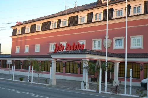 a red building on the side of a street at Hotel Joao Padeiro in Aveiro