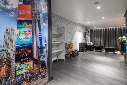 a living room with a large mural of a city at Van der Valk Hotel Utrecht in Utrecht