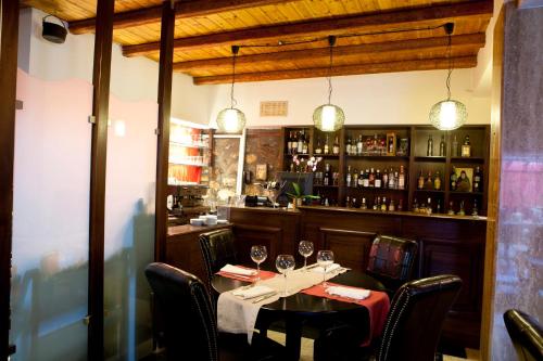 a dining room with a table with wine glasses at Chalet Lithos in Palaios Agios Athanasios