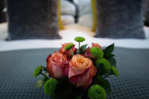 a bouquet of pink roses sitting on a table at Malmaison Oxford in Oxford