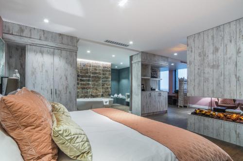 a bedroom with a large bed and a bathroom at Van der Valk Hotel Utrecht in Utrecht