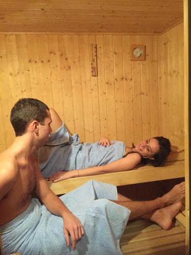 a man and a woman laying in a sauna at Centrale in Courmayeur