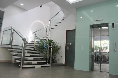 a staircase in a building with a glass door at Malis the Residence in Phnom Penh