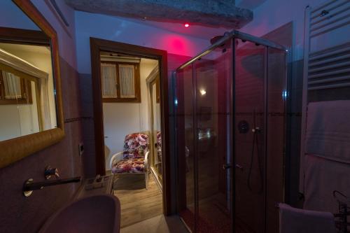 a bathroom with a shower and a chair in a room at Nike Appartamenti in Venice