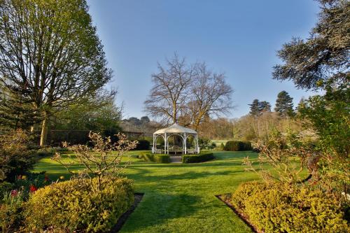 a gazebo in the middle of a garden at Quorn Grange Hotel in Loughborough