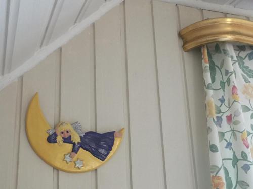 a little girl sitting on the moon on a wall at Vimmerby Lilla utsikten in Tuna