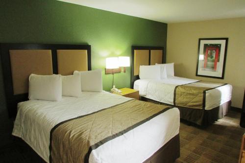 two beds in a hotel room with green walls at Extended Stay America Suites - Seattle - Bothell - Canyon Park in Bothell