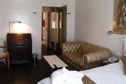 a living room with a couch and a table at Hotel Approach in Knokke-Heist