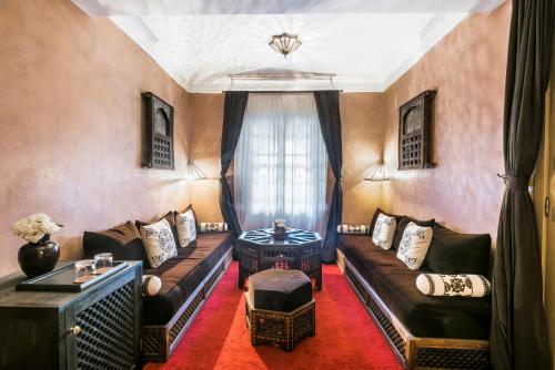 a living room with a couch and a table at Almaha Marrakech Restaurant & SPA in Marrakech