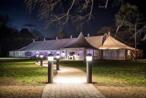 a large tent is lit up at night at The Oaksmere in Eye