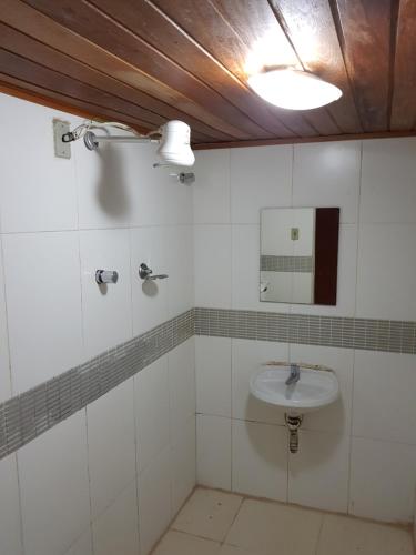 a bathroom with a sink and a mirror at Hotel Cabo Finisterra in Rio de Janeiro