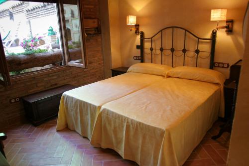 sypialnia z dużym łóżkiem w pokoju w obiekcie Casa Rural Capricho del Valle w mieście Arroyo Frio