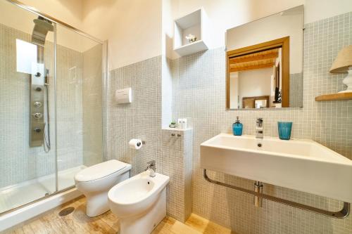 a bathroom with a sink and a toilet and a mirror at Gli Aranci in Agropoli