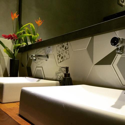 a bathroom with two beds and a sink and a mirror at Viver Bahia Pousada in Salvador