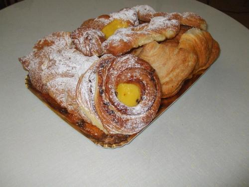 a plate of pastries sitting on a table at Hotel Cucciolo in Donoratico