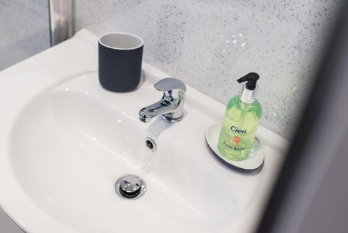 a bathroom sink with a bottle of soap on it at The New Westfield in Edinburgh