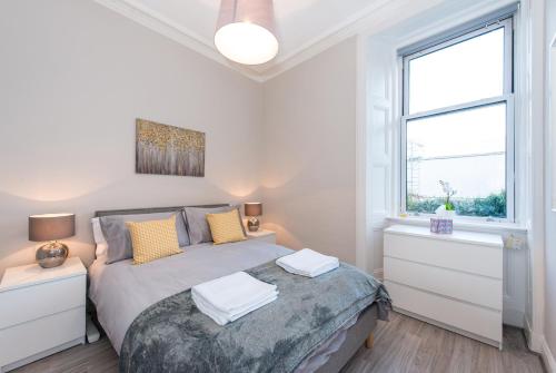 1 dormitorio con cama y ventana en The New Westfield en Edimburgo