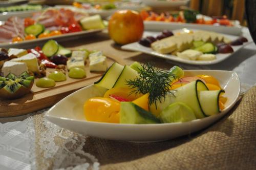 a table topped with plates of different types of food at Hotel Zamkowy Młyn in Krapkowice