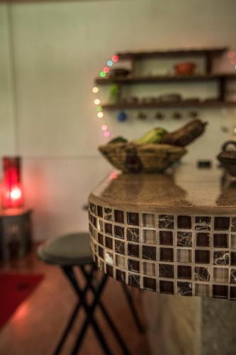 a counter with a bowl of bananas on a table at Blanconejo de Montezuma in Montezuma