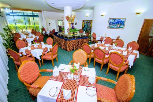 a dining room with tables and chairs and tablesearcher at HOTEL LAKE CASTLE - Parkview in Dhaka
