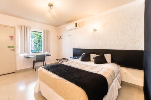a bedroom with a large bed in a room at Concept Design Hostel & Suites in Foz do Iguaçu
