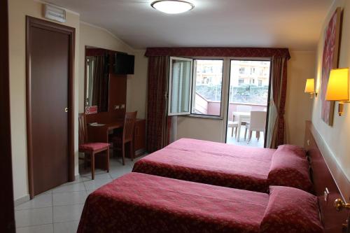 Una cama o camas en una habitación de Hotel Vitti