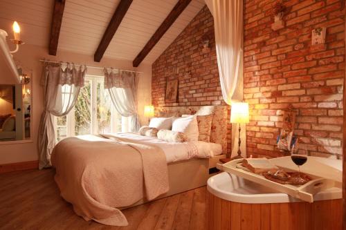 a bedroom with a bed and a brick wall at Weißt Du noch - Gästehäuser & Suiten in Kühlungsborn