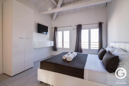 a bedroom with a large bed with towels on it at YPApartments FIERA in Padova