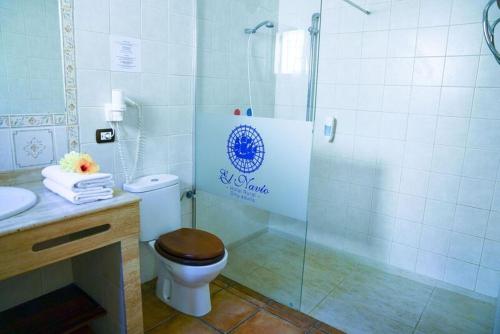 a bathroom with a toilet and a glass shower at Hotel Rural El Navío - Adults Only in Alcalá