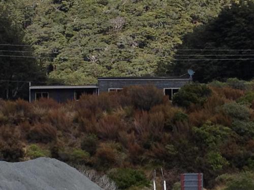 a building on the side of a hill at The Nook in Arthur's Pass
