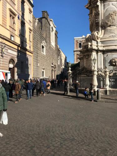 a group of people standing in a street in front of a building at L'Approdo di Dante in Naples