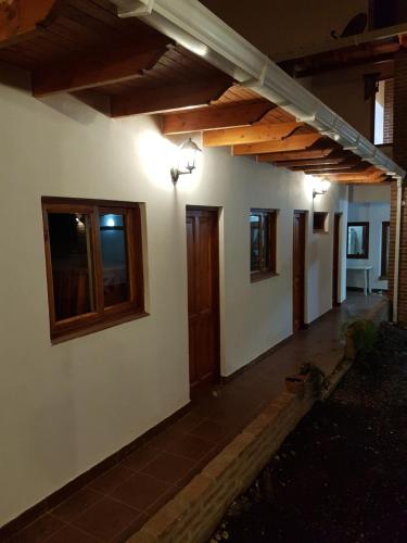 a house with wooden ceilings and windows on it at Accueillant Auberge Salta in Salta