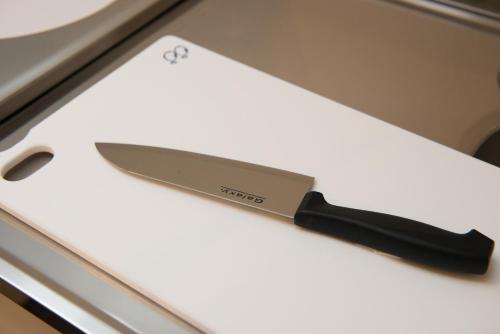 a knife sitting on top of a white board at ETAVIA Yufuinekimae in Yufuin
