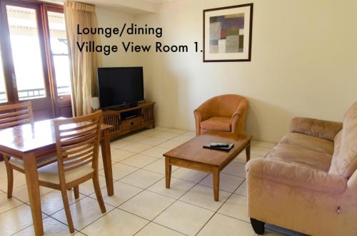 a living room with a couch and a table and a tv at Mayfield on Montville in Montville
