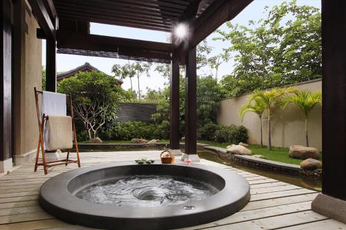 a hot tub in the middle of a patio at Narada Resort & Spa Perfume Bay Sanya - All Villas in Lingshui